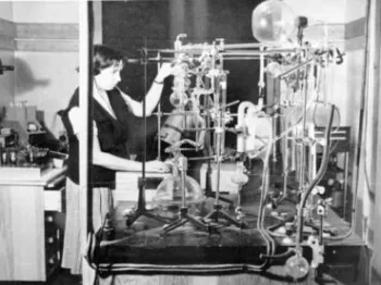 Kobieta obsługuje skomplikowaną aparaturę próżniową w laboratorium.