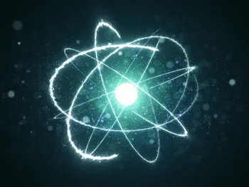 Jasny atom z orbitującymi elektronami na ciemnym tle z efektami świetlnymi.